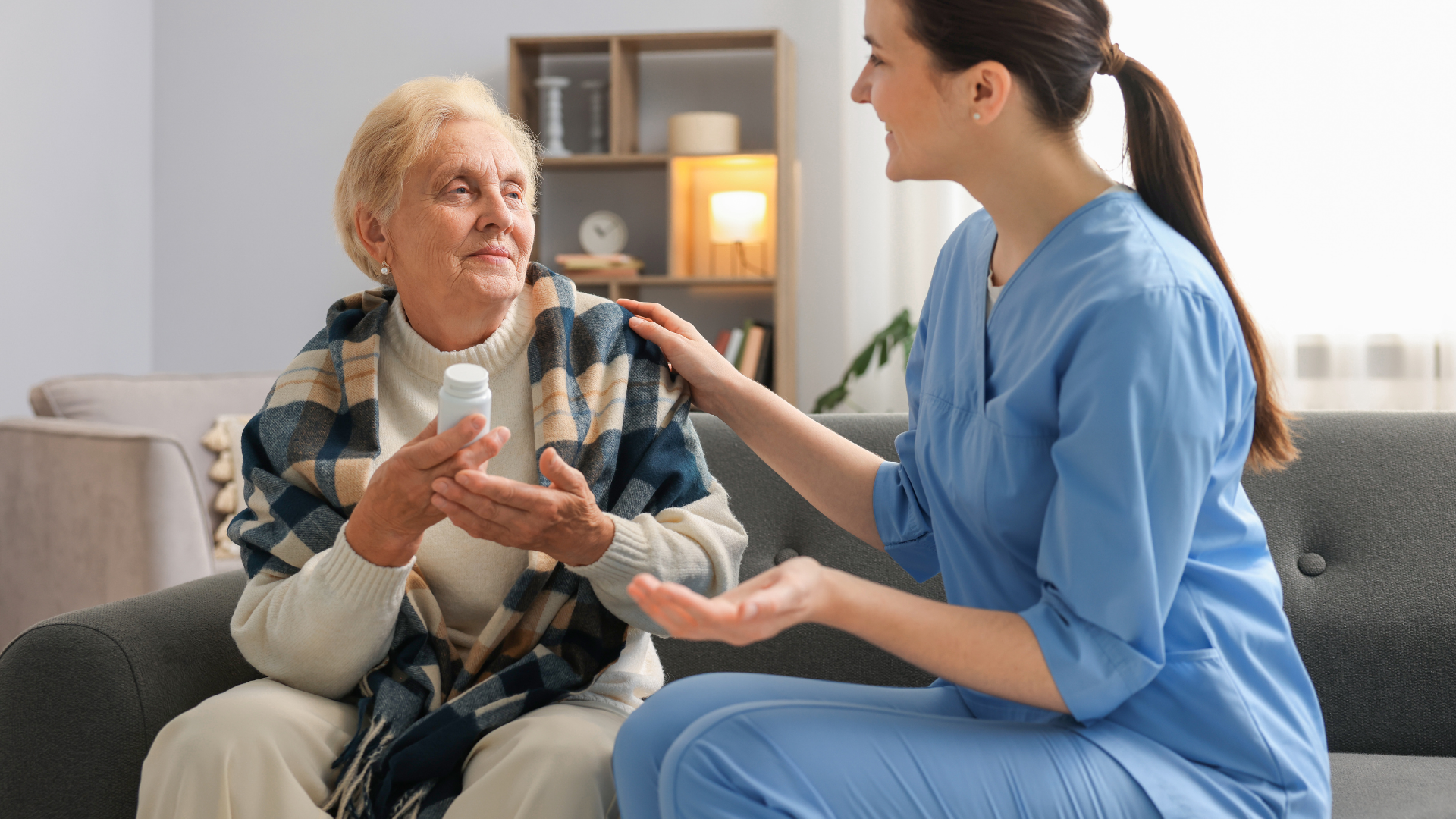 Profesional sanitario con paciente que sostiene un medicamento.